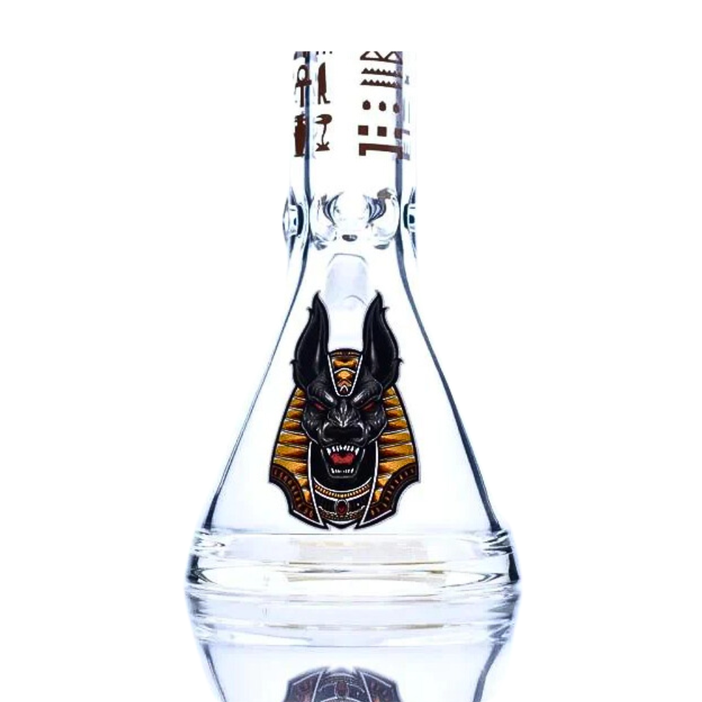 Clear glass bottle with a decorative label featuring a black and orange design on a white background