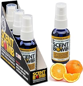 Scent Bomb spray bottles with packaging and oranges on a white background