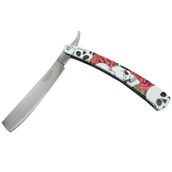 Straight razor with skull and floral design handle on a white background