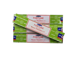 Multiple boxes of Fortune Incense stacked on a white background