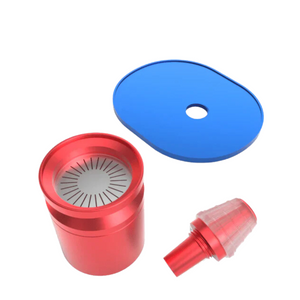 Red metal grinder with blue top cap and red plastic piece on a white background