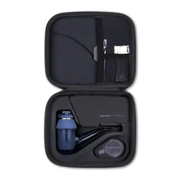 A smart wax pen with a modular design, displayed in an open case, revealing its components including a ceramic bowl, a USB-C charging cable, and other accessories.