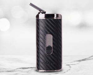 Black carbon fiber vape pen on a marble surface with a light gray background