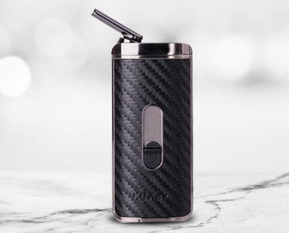 Black carbon fiber vape pen on a marble surface with a light gray background
